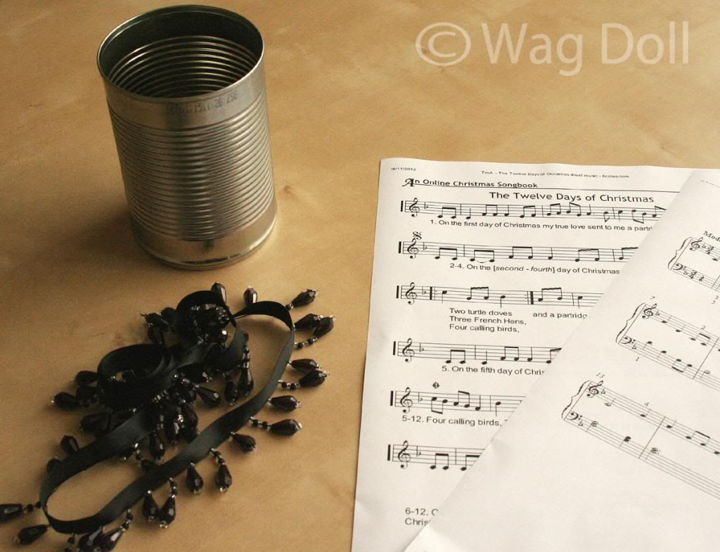 tin can, music manuscript and ribbon