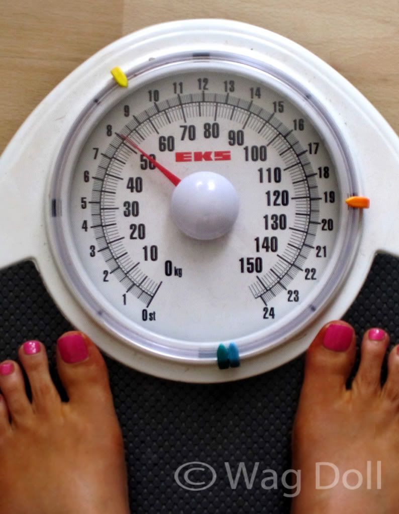 woman being weighed feet on scales